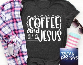 May include: Dark gray t-shirt with the text "give me COFFEE and LOTS OF JESUS" in white. A pink and white plaid shirt and sunglasses are next to the t-shirt. A pink and white striped coffee cup is also visible.