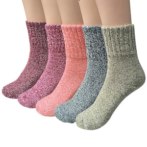 May include: Five pairs of ankle socks in different colours: maroon, cantaloupe, olive, light green, and raspberry. The socks are made of a soft, textured material.