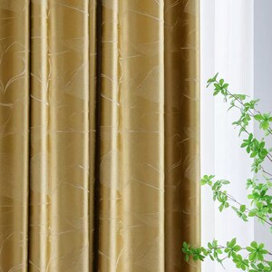 May include: Gold curtains with a subtle, embossed pattern. The curtains are made of a soft, luxurious fabric and have a rich, elegant look.