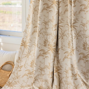 May include: Beige curtain with a gold printed pattern of palm trees and leopards.