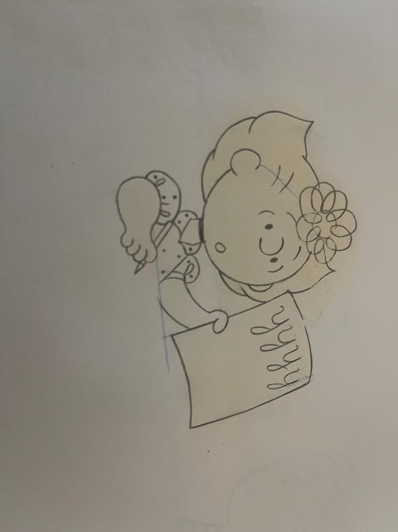 May include: A black and white line drawing of a girl with a flower in her hair, sitting at a desk and writing in a notebook.