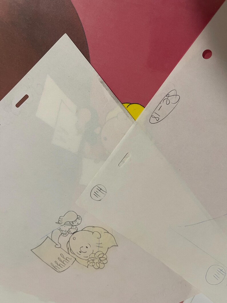 May include: A black and white pencil drawing of a cartoon character holding a piece of paper with the word "hrrhh" written on it. The character is wearing a flower in their hair and has a surprised expression on their face.