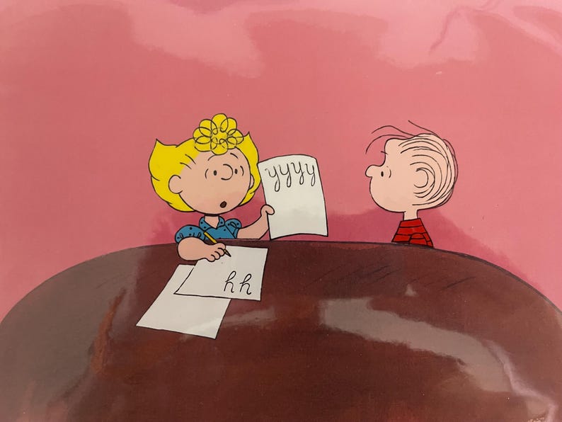 May include: A cartoon illustration of two children sitting at a table, one writing 'yyy' on a piece of paper and the other writing 'hh' on a piece of paper.