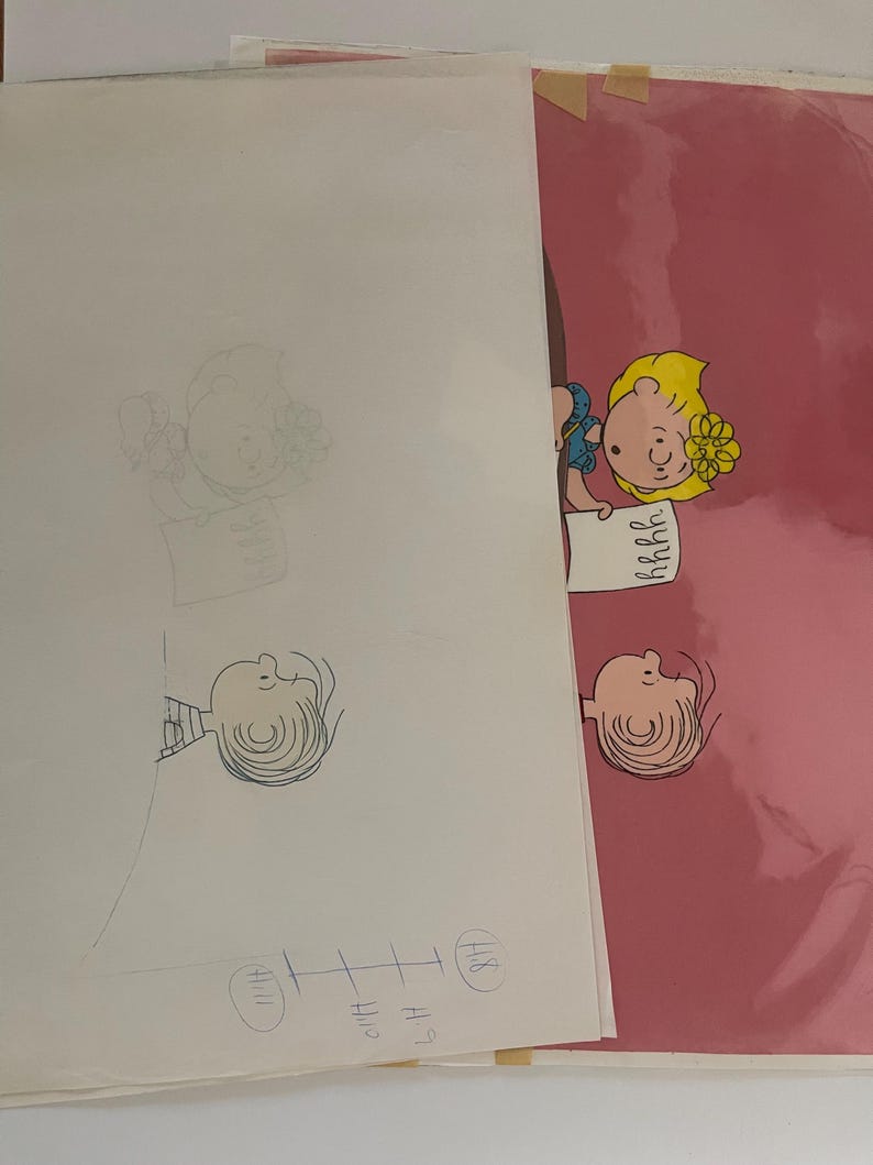 May include: A pink background with a black and white cartoon drawing of a girl with blonde hair and a blue dress. The girl is holding a piece of paper with the word "remarkable" written on it. The drawing is on a clear sheet of paper.