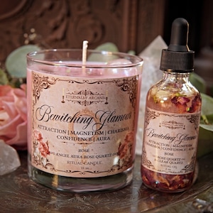 May include: A pink ritual candle and a glass bottle with a dropper, both labeled "Bewitching Glamour." The candle is in a clear glass, and the bottle contains rose petals. The labels have ornate designs.