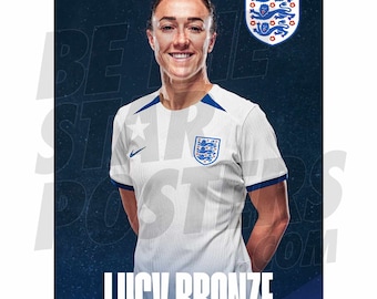 May include: A portrait of Lucy Bronze, a female soccer player, wearing a white soccer jersey with the England national team logo and a star on the left shoulder. She is smiling and has her hands in her pockets. The background is a dark blue.