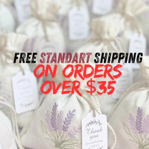 May include: Close-up of several small, beige linen bags tied with twine. Each bag features a lavender sprig embroidery and a small tag. The text "FREE STANDART SHIPPING ON ORDERS OVER $35" is overlaid on the image.