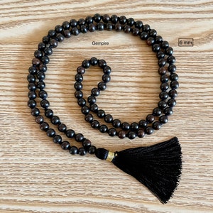 May include: Black wooden beaded necklace with a black tassel. The beads are 6 mm in diameter. Gempire.