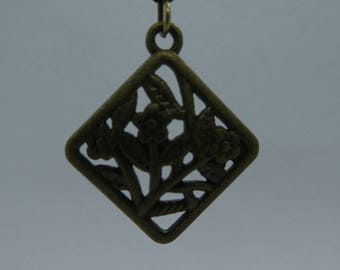 Hanging earring in bronze