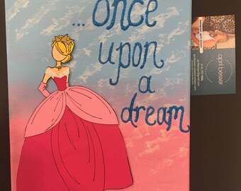 May include: A pink and blue canvas painting with a princess silhouette in a pink gown. The text "...once upon a dream" is written in blue glitter.