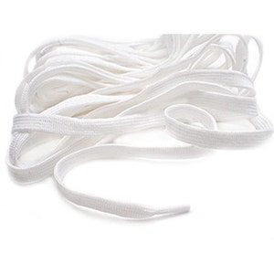 May include: White shoelaces made of a woven fabric. The shoelaces are coiled and arranged in a loose pile.