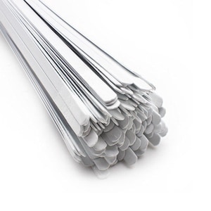 May include: A bundle of white metal strips, likely for crafting or DIY projects. The strips are bundled together and have a slightly rounded edge.