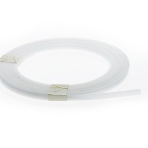 May include: A white plastic trim molding, coiled and ready for use. The trim is approximately 1/2 inch wide.