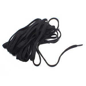 May include: A close-up of a black shoelace, coiled and ready to be used.