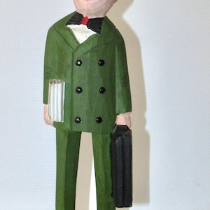 Nice folk art wood carving salesman with his samples / order book