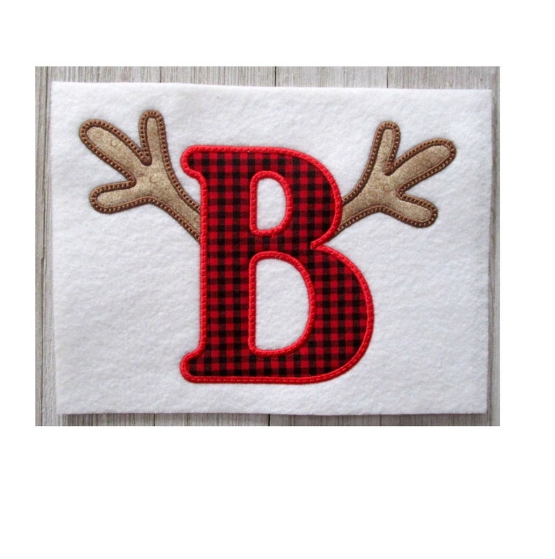 May include: Red and black buffalo check letter B with brown reindeer antlers.