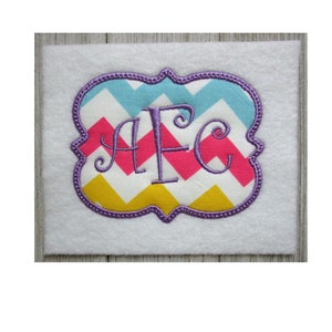 May include: Purple embroidered monogram "AFC" in a decorative frame with a chevron pattern in pink, yellow, blue and white.