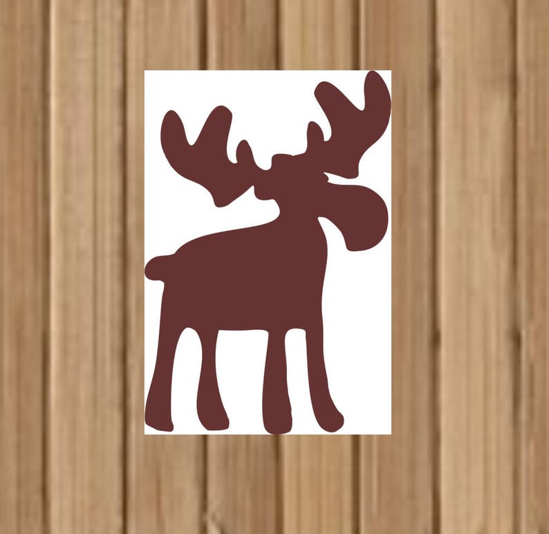 May include: A brown moose silhouette cut out from white paper. The moose has large antlers and a long snout.