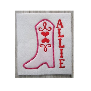 May include: Pink and red embroidered cowboy boot with the name Allie stitched next to it.