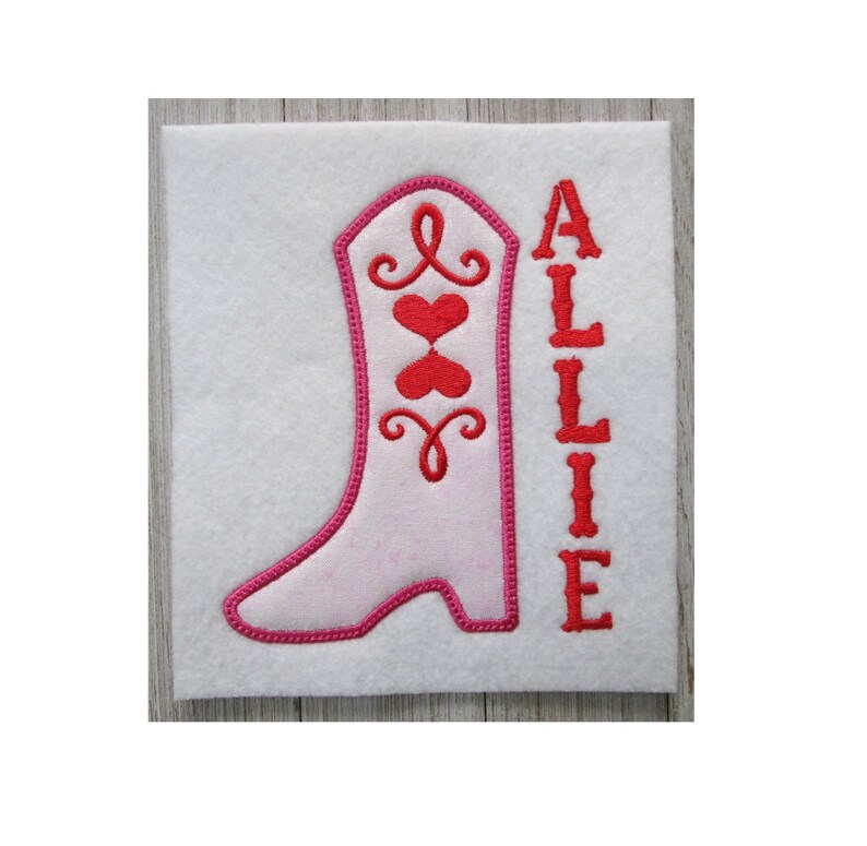 May include: Pink and red embroidered cowboy boot with the name Allie stitched next to it.
