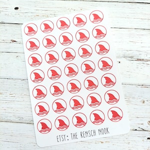 May include: A sheet of stickers featuring a red shark fin design within a red circle, above wavy lines. The stickers are on a white background, with the text "ETSY: The Rensch Nook" at the bottom.