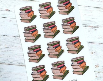 May include: A sheet of stickers featuring stacks of books with colorful spines. The books have green, orange, pink, and brown covers. The text "ETSY: THE RENSCH NOOK" is printed at the bottom of the sheet.