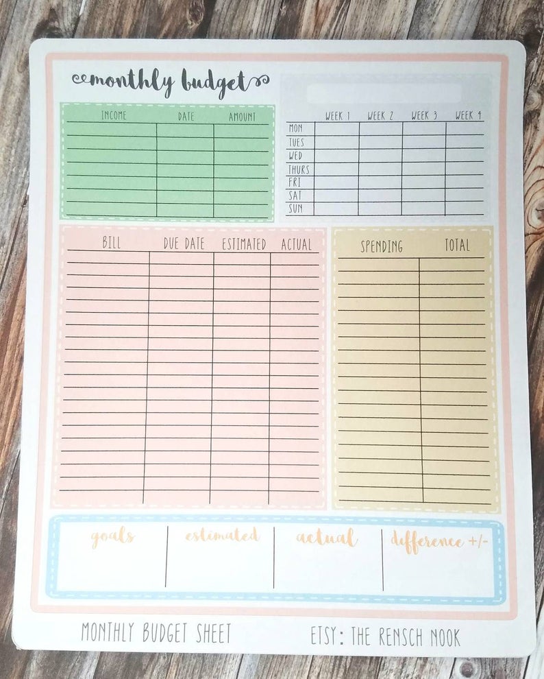 May include: A printable monthly budget sheet with sections for income, bills, spending, and goals. The sheet is divided into four sections with different colored backgrounds: green, pink, yellow, and blue.