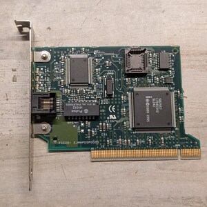 May include: A green printed circuit board network interface card featuring a metal mounting bracket, an RJ45 ethernet port, and multiple integrated circuits including a Pulse H1012 chip and an Intel S82557 processor with 1989 1995 markings.