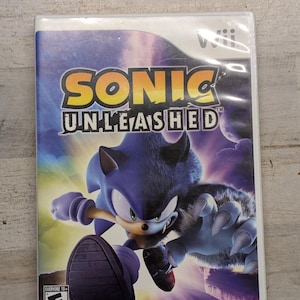 May include: A Sonic Unleashed video game case for the Wii console. The cover art features a split image of Sonic the Hedgehog and his werewolf form against a purple night sky. The ESRB 10+ rating icon is in the bottom left corner and Sega logo.