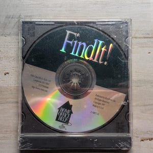 May include: A sealed FindIt! software CD in a clear plastic jewel case. The disc features a holographic finish with the title FindIt! in large letters, a Home Office Help logo, and printed text including address, copyright 1997, and Made in USA.