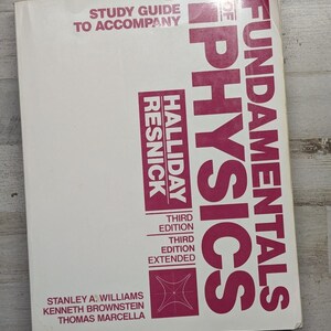 May include: A white softcover textbook titled Study Guide to Accompany Fundamentals of Physics, Third Edition Extended by Halliday, Resnick, Williams, Brownstein, and Marcella. The cover features bold magenta text and a small geometric line graphic.