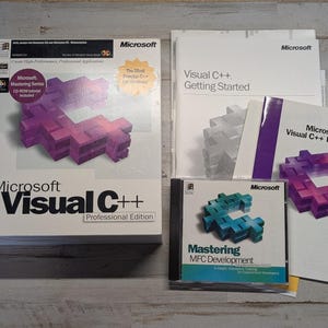 May include: A Microsoft Visual C++ Professional Edition software box set including a large white box with a purple C-shaped graphic, a Getting Started manual, a Visual C++ Directory booklet, and a Mastering MFC Development CD-ROM case.