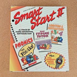 May include: A Smart Start 3-pack software box set featuring Phonics, Typing Tutor, and Addition & Subtraction programs. The cover displays colorful cartoon dinosaurs, a digital watch offer, and the text Ages 4 to Adult on a lined notebook background.