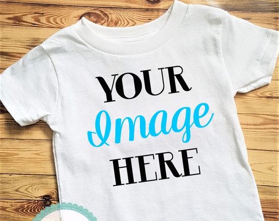 White Blank Toddler Tee Mockup Image Wood Background White Blank Toddler Tee Mockup Image Wood Background