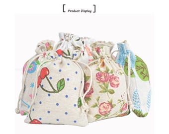 May include: Set of six small drawstring bags made of natural linen fabric with various floral and polka dot patterns. The bags are perfect for gift wrapping, party favors, or storing small items.