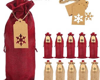 May include: Twelve red burlap wine bottle bags with snowflake-shaped brown paper gift tags. The bags are tied with twine and have a rustic look. The tags are blank and ready for personalisation.