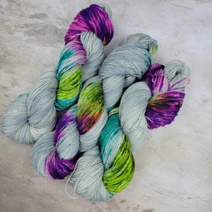 Hand Dyed Yarn in New Day Colorway: Gray Yarn with Blue, Green, and Purple Speckles