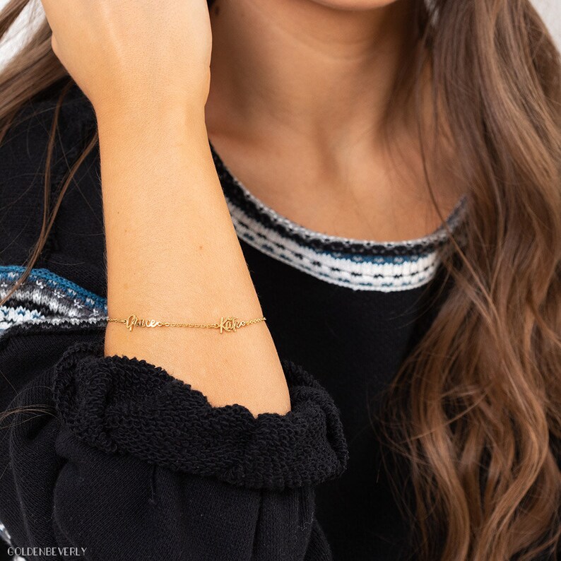 May include: Gold chain bracelet with the names "Grace" and "Kate" spelled out in cursive.