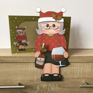 Older lady drinking brandy on the shelf christmas card and envelope
