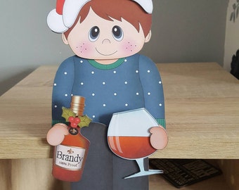 Young male drinking brandy on the shelf christmas card and envelope