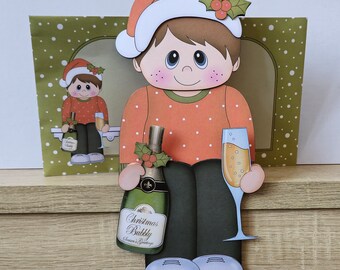 Young male drinking champagne on the shelf christmas card and envelope