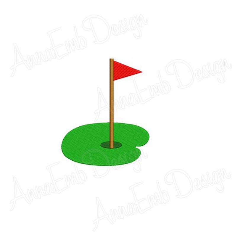 May include: A red flag on a brown pole stands in a green golf hole.