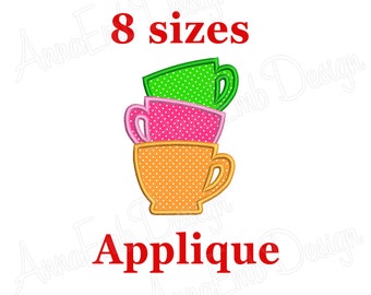 May include: An applique design featuring three stacked teacups in orange, pink, and green, each with white polka dots. The text "8 sizes" and "Applique" are in red.