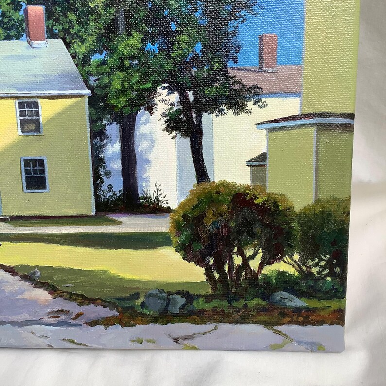 May include: A painting of a yellow house with a green roof and a white house in the background. There are trees and bushes in the foreground.