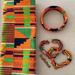 May include: A set of African print fabric accessories including a headband, a pair of large hoop earrings, and a rectangular piece of fabric with a colorful geometric pattern.