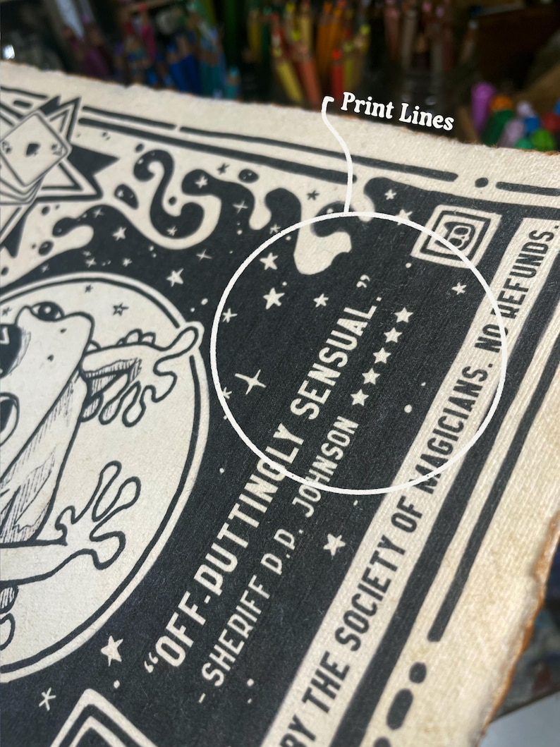 May include: Black and white illustration of a frog with the text "OFF-DUTTINGLY SENSUAL." SHERIFF D.D. JOHNSON ★  BY THE SOCIETY OF MAGICIANS. NO REFUNDS.