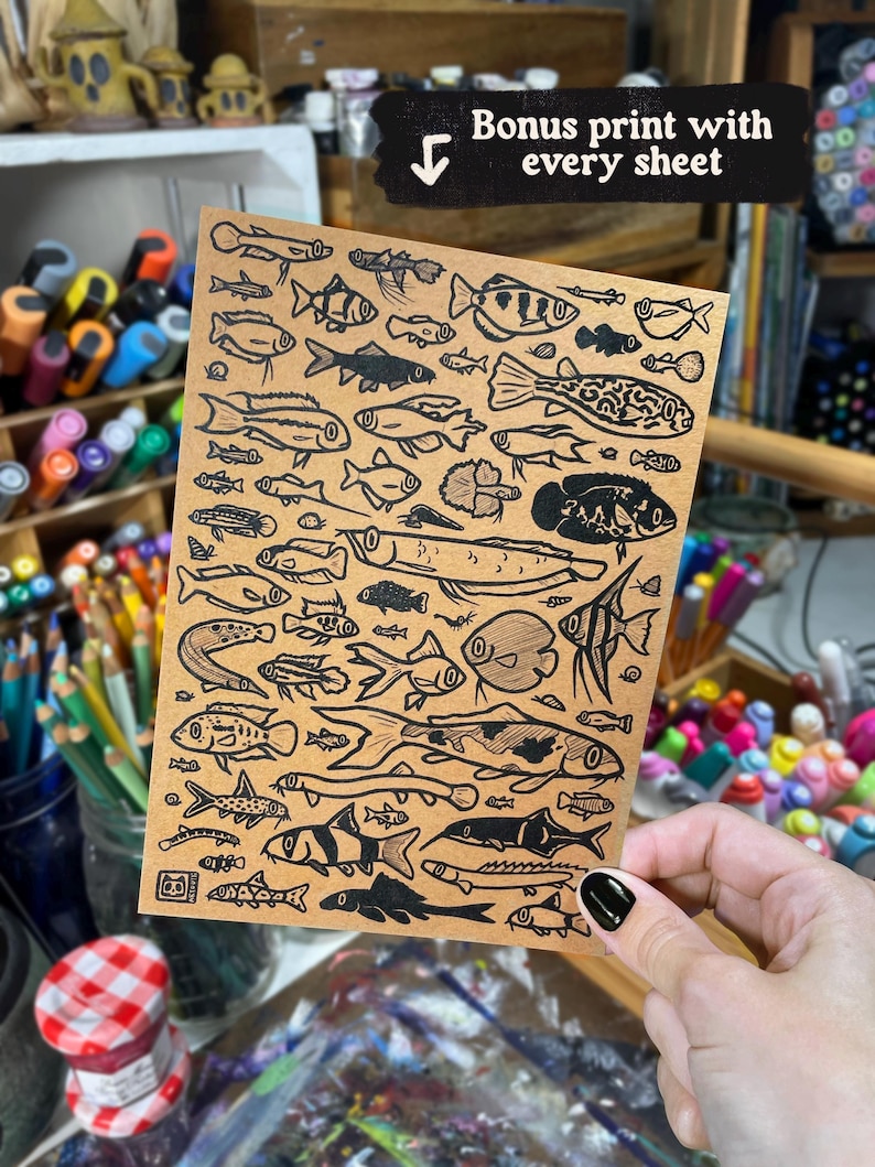 May include: A rectangular tan sheet of paper featuring a dense collection of black ink illustrations of various fish species. The top of the sheet includes a black banner with the white text "Bonus print with every sheet" and a downward arrow.