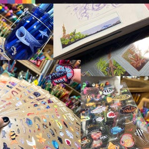 May include: Clear stickers featuring various aquatic life, including fish and a whale shark, are displayed. The stickers are clear and showcase detailed illustrations of marine creatures. The image also shows a jar with pencils and a notebook with a landscape drawing.