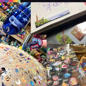 May include: A collection of clear stickers featuring various aquatic life, including a whale shark, betta fish, and numerous small tropical fish. The stickers are displayed on sheets and applied to a blue glass jar and a notebook, with the text Clear Stickers.