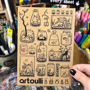 May include: A brown paper print featuring various jar illustrations with plants and creatures, in a black line art style. The print includes the text "artoulli" and "Bonus print with every sheet".